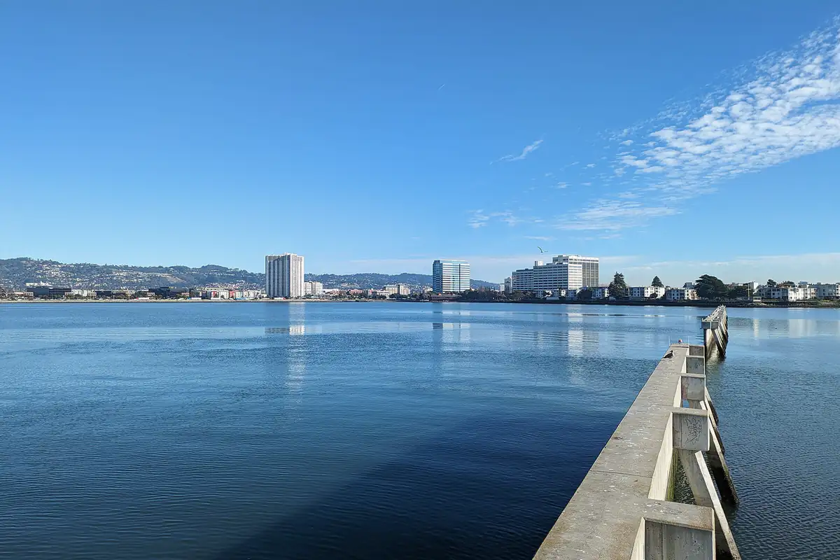 A wide bay and city skyline viewed from Emeryville